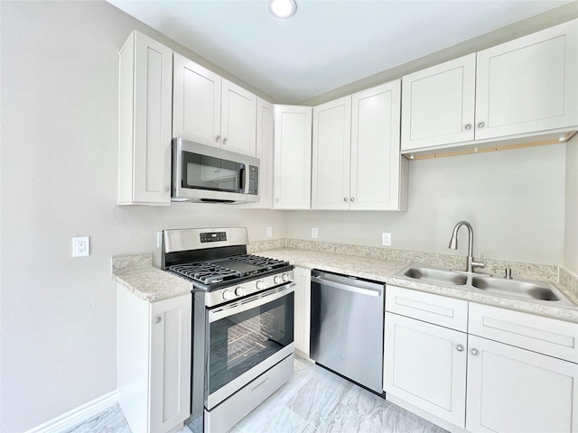 5602 Hirondel St A/B, Unit A/B Houston, TX 77033 - kitchen featuring a sink, appliances with stainless steel finishes, and white cabinetry