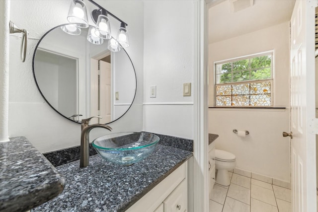 bathroom featuring toilet, tile patterned floors, visible vents, and vanity