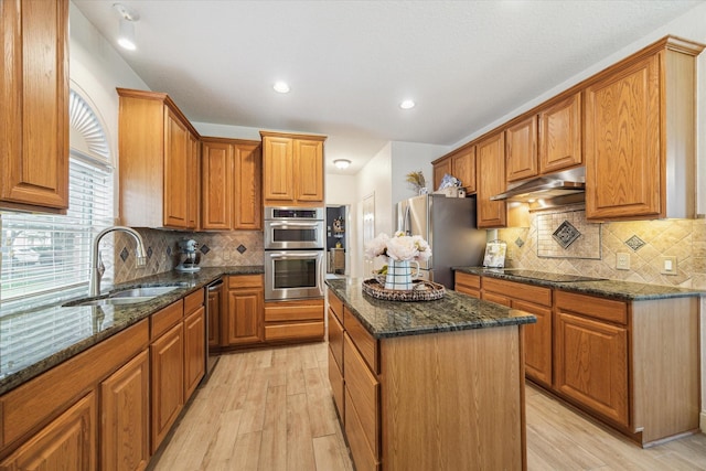 4406 Tarlton Way, Sugar Land, TX 77478 - kitchen featuring a sink, appliances with stainless steel finishes, under cabinet range hood, light wood finished floors, and recessed lighting