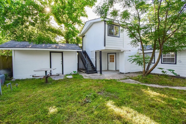 view of front of house with fence, a front yard, and stairs