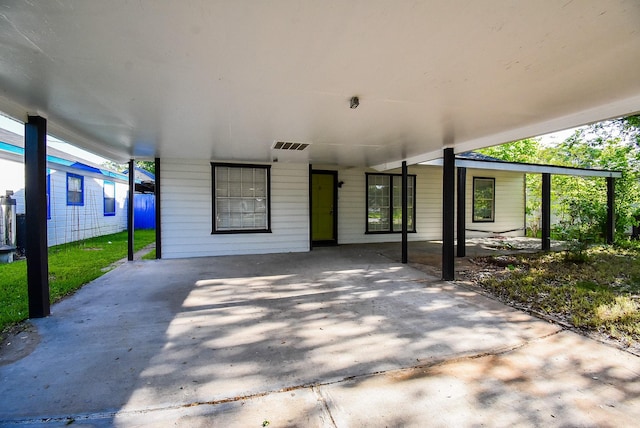 view of patio with a carport and visible vents