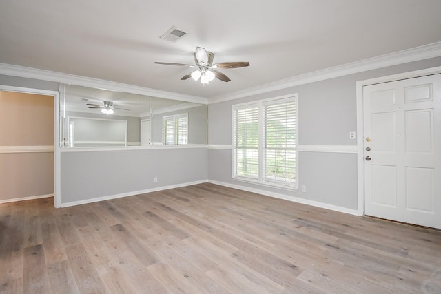 unfurnished room featuring baseboards, ornamental molding, a ceiling fan, and light wood-style floors
