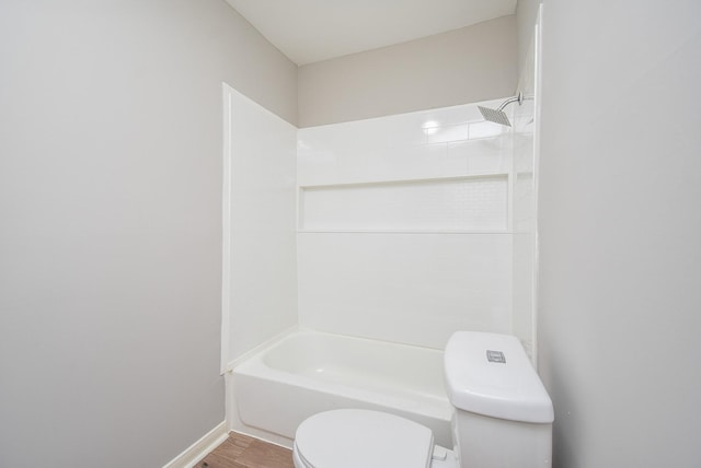 full bathroom featuring toilet, shower / washtub combination, and wood finished floors