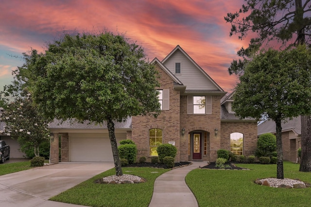 2218 Dawn Wind Ln, Spring, TX 77386 - view of front of house featuring a yard, brick siding, driveway, and a garage