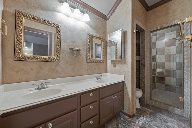 bathroom with double vanity, toilet, a sink, and a stall shower