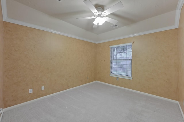 unfurnished room featuring crown molding, carpet floors, ceiling fan, and visible vents