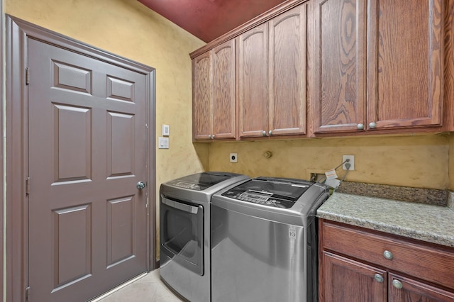 washroom featuring cabinet space and washer and dryer
