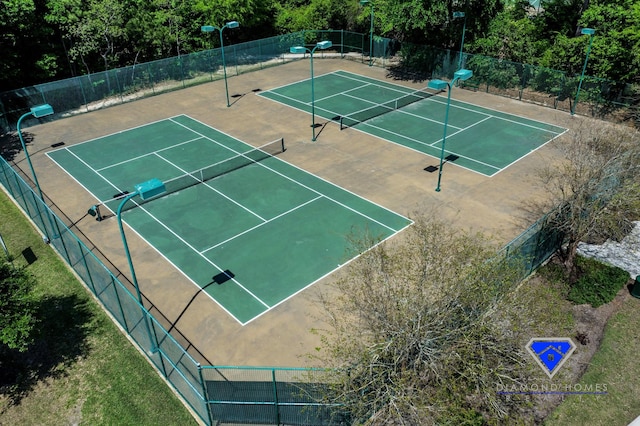 view of tennis court featuring fence