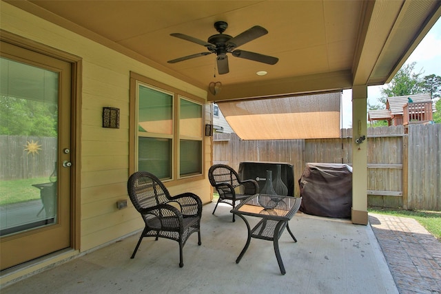 view of patio with a fenced backyard, a ceiling fan, and area for grilling