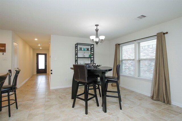 dining space with an inviting chandelier, baseboards, light tile patterned flooring, and visible vents