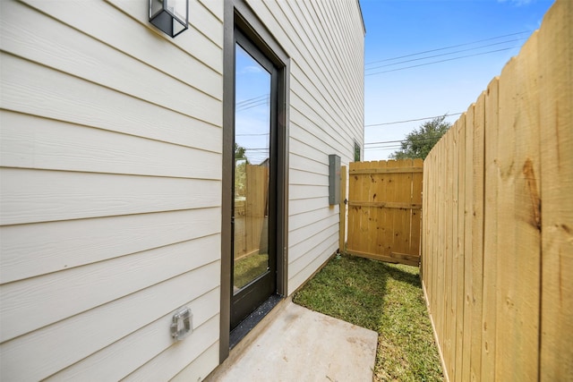 view of side of home featuring fence