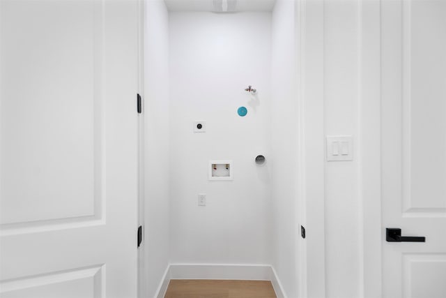 clothes washing area with washer hookup, gas dryer hookup, electric dryer hookup, baseboards, and light wood finished floors