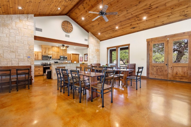 dining area featuring a ceiling fan, concrete flooring, and visible vents