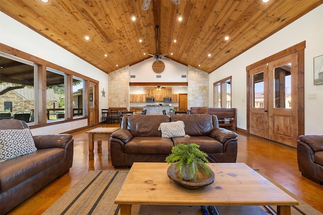 living room with vaulted ceiling, ceiling fan, wooden ceiling, and a wealth of natural light