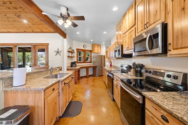 kitchen with light stone counters, stainless steel appliances, finished concrete floors, a sink, and a ceiling fan