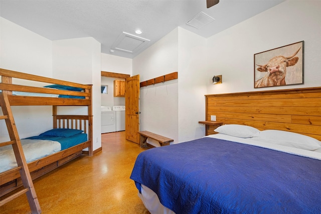 bedroom with attic access, visible vents, ceiling fan, and washer and clothes dryer