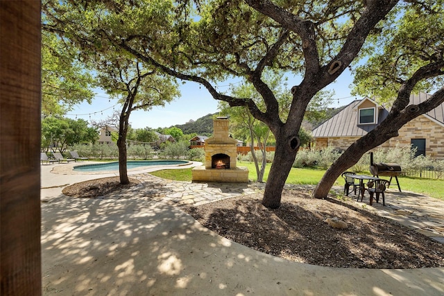 surrounding community featuring a patio and a pool