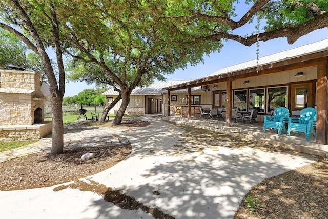 exterior space with fence and an outdoor stone fireplace