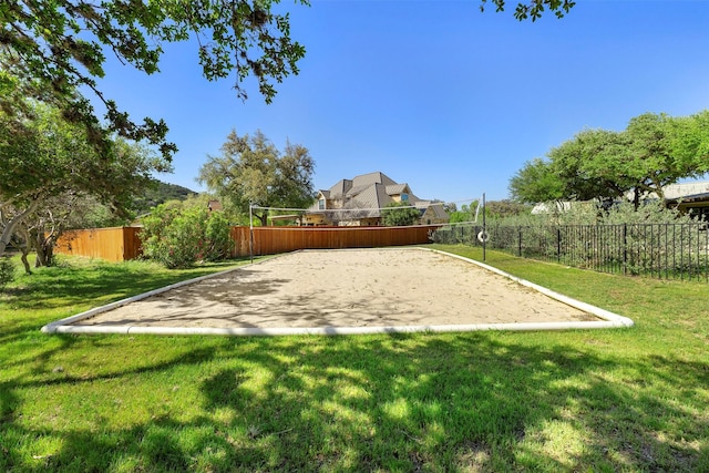 surrounding community featuring fence, a lawn, and volleyball court
