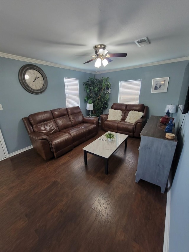 living room featuring visible vents, ornamental molding, a ceiling fan, and plenty of natural light