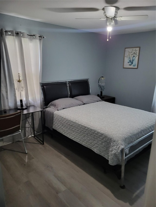 bedroom featuring ceiling fan and wood finished floors