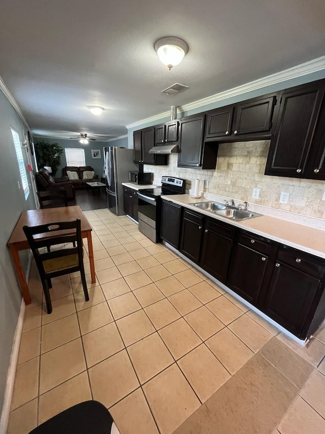 kitchen featuring decorative backsplash, a sink, visible vents, stainless steel appliances, and ornamental molding