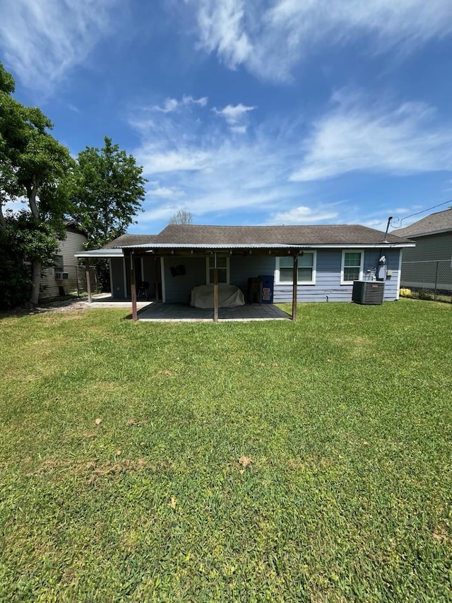 rear view of house featuring a patio, cooling unit, and a lawn