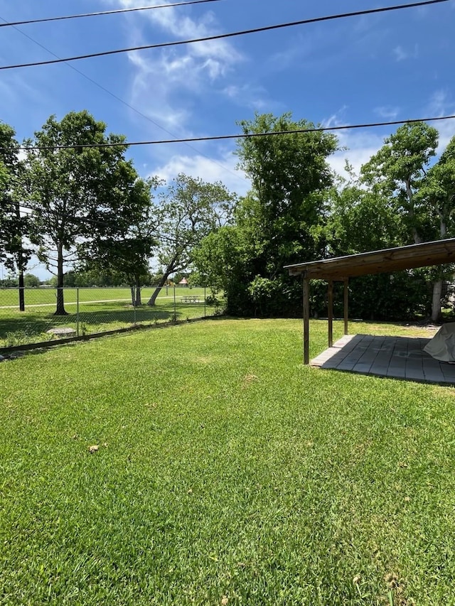 view of yard with fence and a patio area