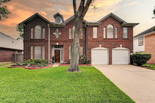 939 Legend Spring Dr, Katy, TX 77494 - view of front of home with fence, an attached garage, brick siding, driveway, and a front yard