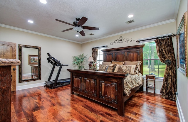 bedroom featuring multiple windows, dark wood-style flooring, and visible vents