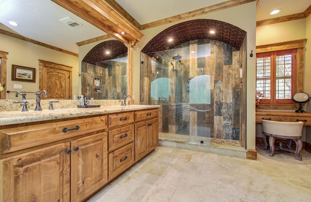 full bath with visible vents, ornamental molding, a sink, and a shower stall