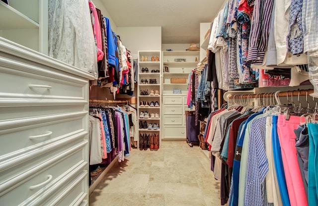 spacious closet with stone finish flooring