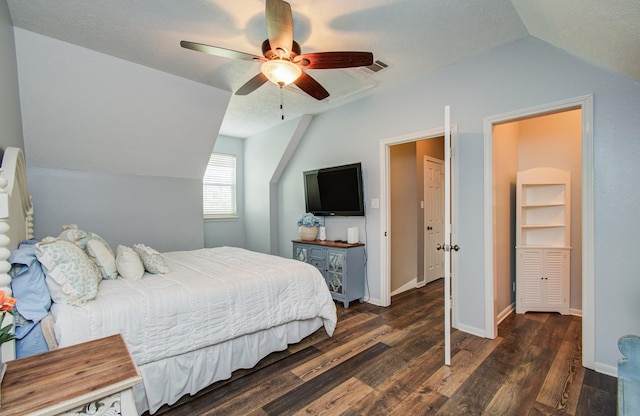bedroom featuring wood finished floors, a ceiling fan, baseboards, and lofted ceiling