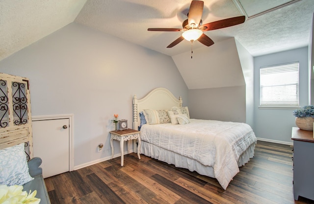 bedroom with vaulted ceiling, dark wood-style floors, and a textured ceiling