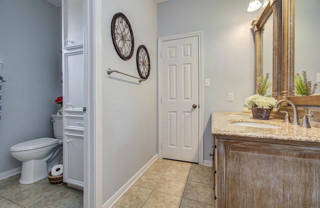 bathroom with tile patterned flooring, baseboards, toilet, and vanity