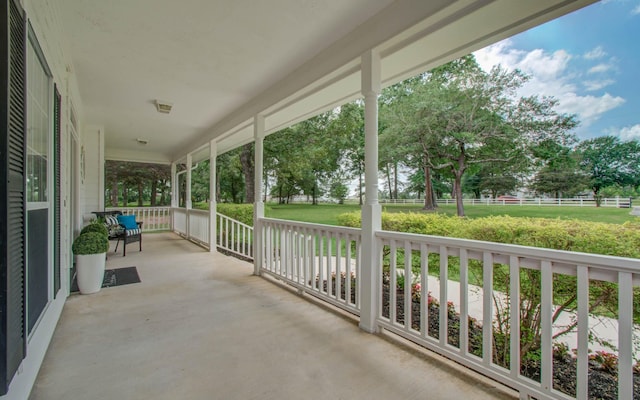 view of patio featuring fence and covered porch