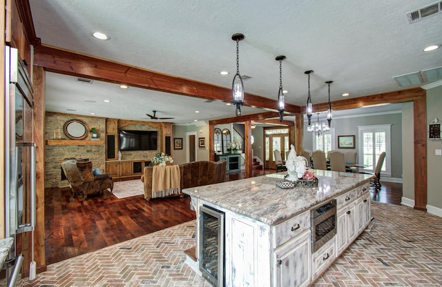 kitchen featuring visible vents, baseboards, open floor plan, recessed lighting, and white cabinetry