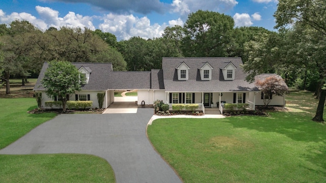 cape cod-style house with roof with shingles, a front lawn, a porch, a forest view, and driveway