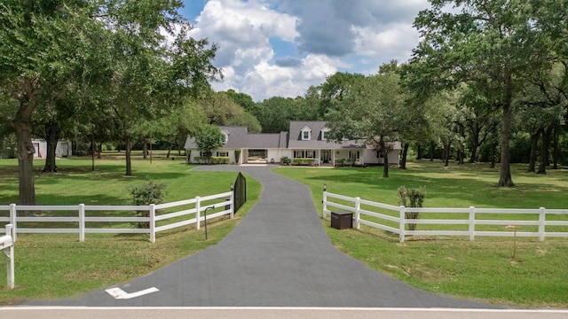 exterior space featuring covered porch, fence private yard, and a front yard