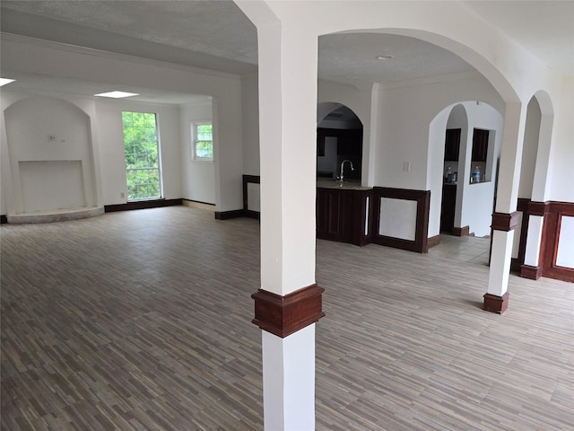 unfurnished living room featuring wood finished floors and baseboards