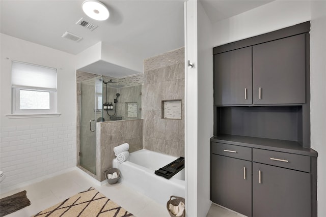 bathroom featuring visible vents, toilet, tile patterned floors, a bath, and a shower stall