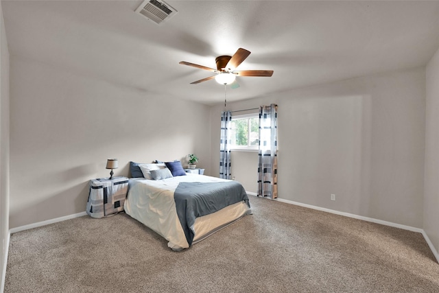 carpeted bedroom featuring visible vents, baseboards, and ceiling fan