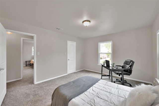 carpeted bedroom featuring baseboards and visible vents