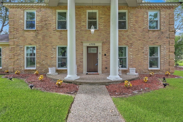 view of front of property with brick siding and a front lawn