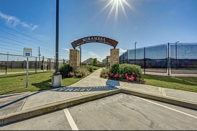 view of community with fence and a yard