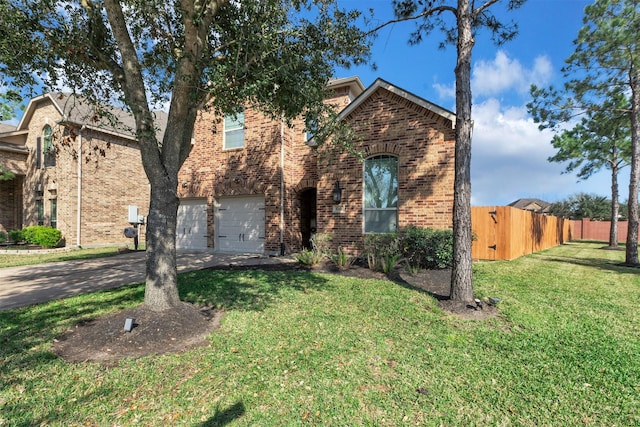view of front of property featuring a front yard, driveway, brick siding, an attached garage, and fence