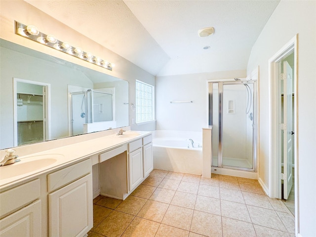full bath featuring double vanity, a shower stall, a bath, and a sink