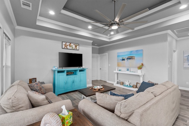 886 Sandollar, Crystal Beach, TX 77650 - living area featuring a tray ceiling, a ceiling fan, visible vents, baseboards, and wood finished floors