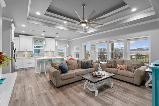 886 Sandollar, Crystal Beach, TX 77650 - living area featuring crown molding, a raised ceiling, and a healthy amount of sunlight