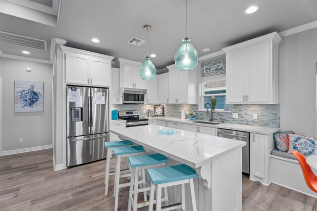 886 Sandollar, Crystal Beach, TX 77650 - kitchen featuring visible vents, stainless steel appliances, ornamental molding, and a sink